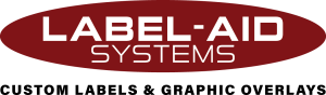 Logo of Label-Aid Systems featuring an oval shape with the company name in white letters and the tagline 'CUSTOM LABEL & GRAPHIC OVERLAYS' below it.